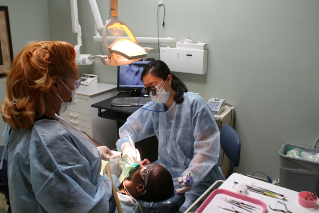 doctors working on patients mouth