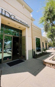 Exterior view of IDC San Bernardino office from a right angle with the door open, welcoming patients inside.